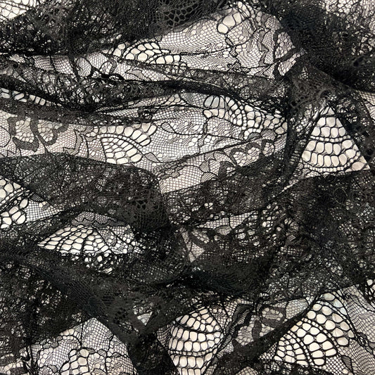 Close-up of Tiss'ART EUGENIA dentelle lace fabric in intricate floral pattern with delicate lace detailing.