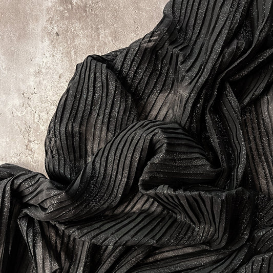 Tiss'ART Regina plissé polyester curtain fabric with a textured, pleated design in neutral tones.