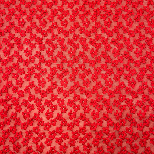 Red floral embroidered tulle fabric by Tiss'ART, showcasing intricate flower designs on a delicate sheer background.